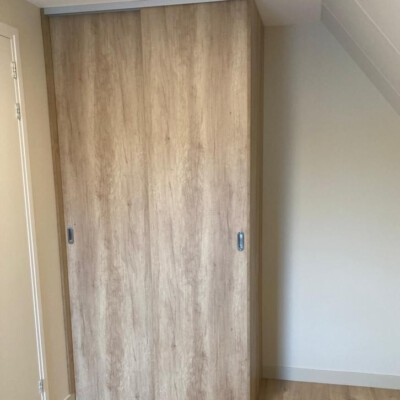 Maatwerk kast met gesloten houten schuifdeuren